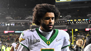 Nov 8, 2025; Iowa City, Iowa, USA; Oregon Ducks quarterback Dante Moore (5) runs off the field after the game against the Iowa Hawkeyes at Kinnick Stadium. Mandatory Credit: Jeffrey Becker-Imagn Images