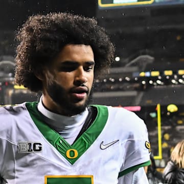 Nov 8, 2025; Iowa City, Iowa, USA; Oregon Ducks quarterback Dante Moore (5) runs off the field after the game against the Iowa Hawkeyes at Kinnick Stadium. Mandatory Credit: Jeffrey Becker-Imagn Images