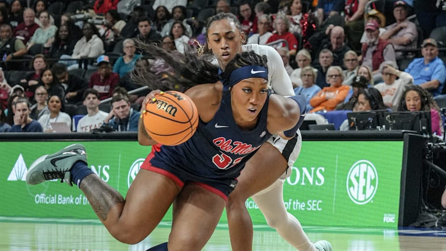 Ole Miss forward Cotie McMahon (32) dribbles by Vanderbilt guard Mikayla Blakes 