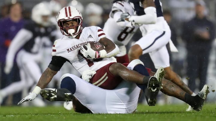 Oct 14, 2023; University Park, Pennsylvania, USA; Massachusetts Minutemen running back Kay'Ron Lynch-Adams (15) is tackled by Penn State Nittany Lions defensive tackle Dvon Ellies (91) during the third quarter at Beaver Stadium. Penn State won 63-0. Mandatory Credit: Matthew O'Haren-USA TODAY Sports