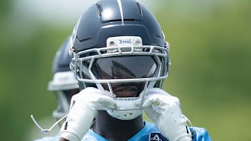Tennessee Titans wide receiver Calvin Ridley straps on his helmet for drills during mandatory Titans Minicamp.