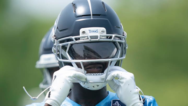Tennessee Titans wide receiver Calvin Ridley straps on his helmet for drills during mandatory Titans Minicamp. Tennessee Titans wide receiver Calvin Ridley straps on his helmet for drills during mandatory Titans Minicamp.