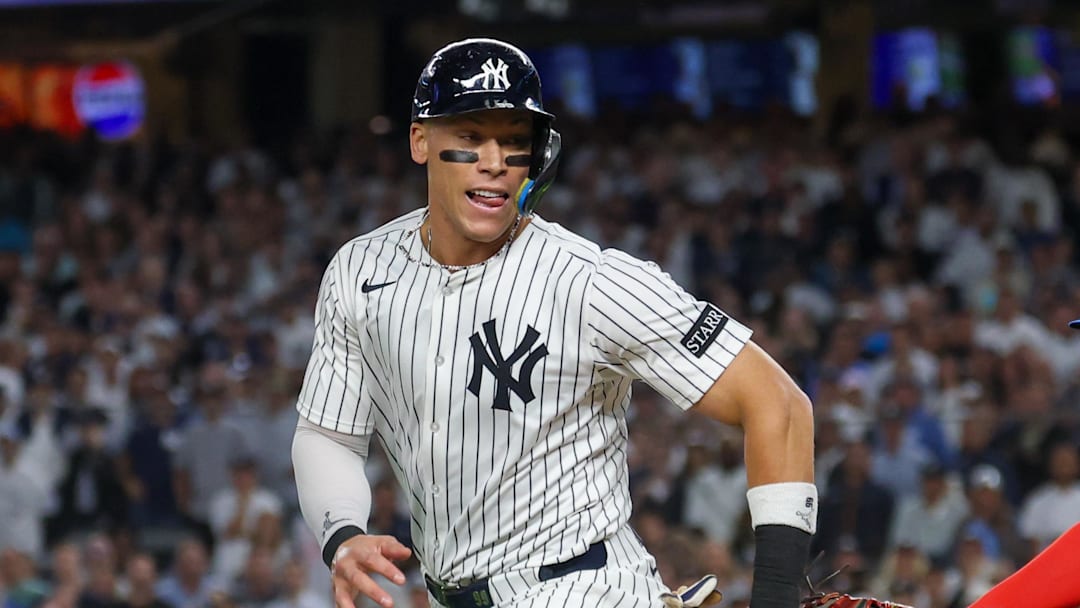 Oct 7, 2025; Bronx, New York, USA; New York Yankees outfielder Aaron Judge (99) is tagged out by Toronto Blue Jays first baseman Vladimir Guerrero Jr. (27) in the third inning during game three of the ALDS round for the 2025 MLB playoffs at Yankee Stadium. Mandatory Credit: Vincent Carchietta-Imagn Images