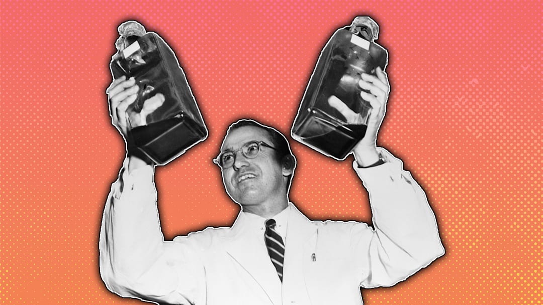 Jonas Salk with bottles of the polio vaccine he developed.