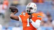 Miami quarterback Cam Ward warms up before a game.