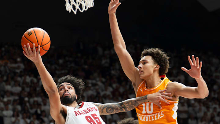 Jan 24, 2026; Tuscaloosa, AL, USA; Alabama guard Houston Mallette (95) scores as he is defended by Tennessee forward Nate Ament (10) at Coleman Coliseum. Mandatory Credit: Gary Cosby Jr.-Tuscaloosa News