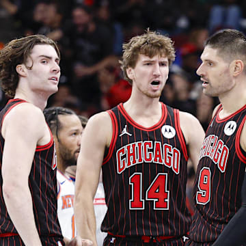 Oct 31, 2025; Chicago, Illinois, USA; Chicago Bulls guard Josh Giddey (3), forward Matas Buzelis (14) and center Nikola Vucevic (9) celebrate during the second half of an NBA game against the New York Knicks at United Center. Mandatory Credit: Kamil Krzaczynski-Imagn Images
