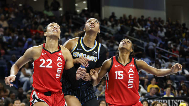 Aug 25, 2024; Chicago, Illinois, USA; Chicago Sky forward Angel Reese (5) is defended by Las Vegas Aces center A'ja Wilson (22) and guard Tiffany Hayes (15) during the first half at Wintrust Arena. Mandatory Credit: Kamil Krzaczynski-USA TODAY Sports