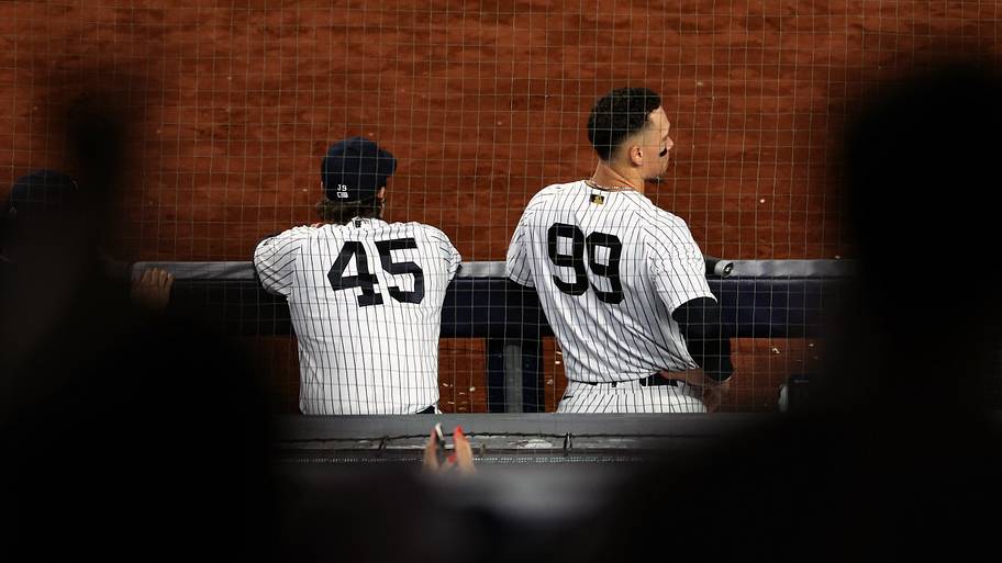 Yankees players Gerrit Cole (left) and Aaron Judge leaning on the dugout railing