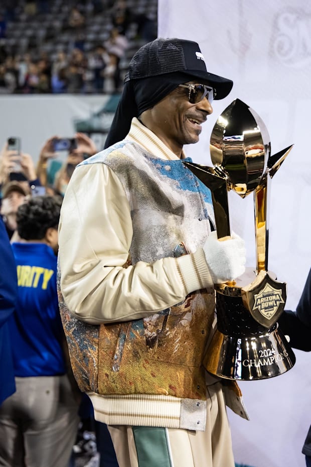 Rapper Snoop Dogg holds the trophy during the Colorado State Rams game