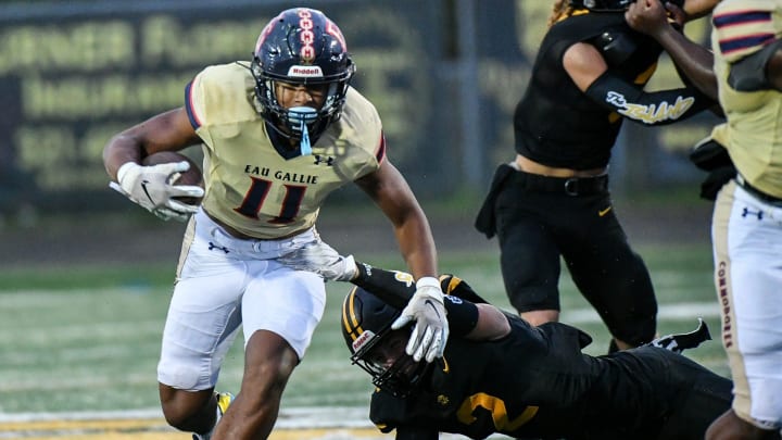 Xavier Lherisse (11) of Eau Gallie runs through a tackle