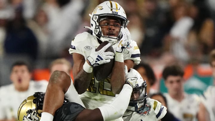 Dec 22, 2023; Tampa, FL, USA; Georgia Tech Yellow Jackets defensive back Ahmari Harvey (18) intercepts the a pass intended for UCF Knights wide receiver Kobe Hudson (2) during the second half of the Gasparilla Bowl at Raymond James Stadium. Mandatory Credit: Jasen Vinlove-USA TODAY Sports