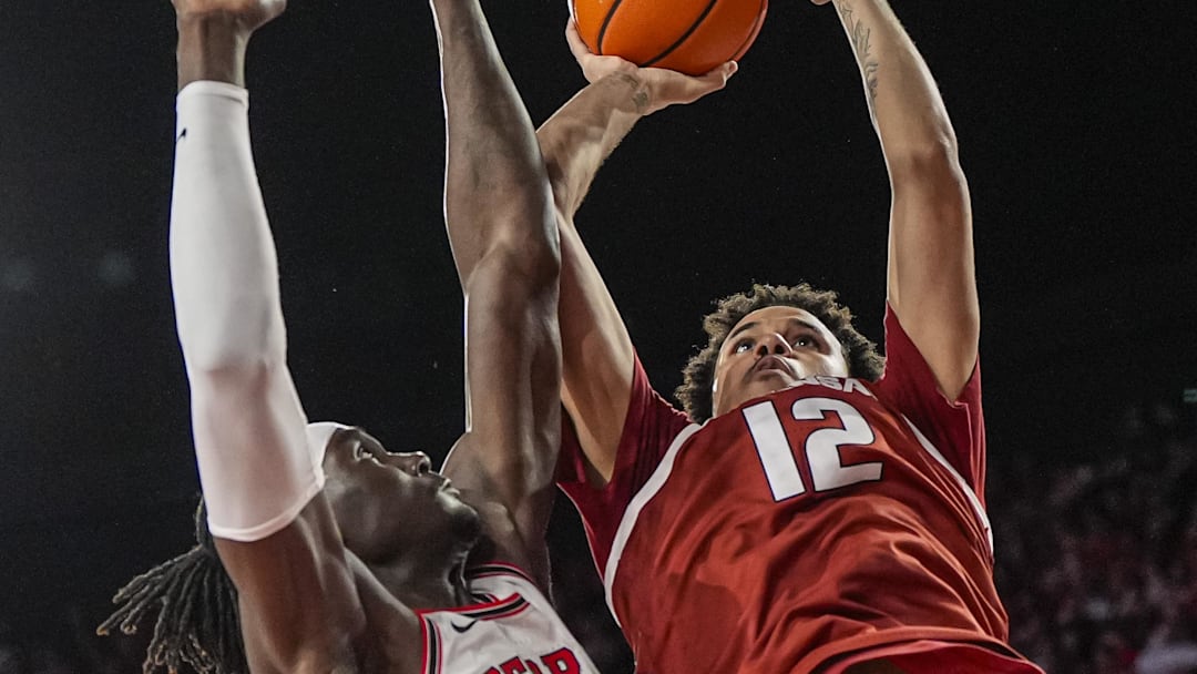 Arkansas forward Malique Ewin (12) shoots against Georgia center Somto Cyril (2) during the second half at Stegeman Coliseum. Mandatory Credit: Dale Zanine-Imagn Images