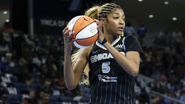 A photo of Angel Reese pulling down a rebound