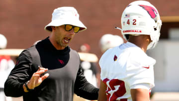 Arizona Cardinals head coach Jonathan Gannon talks to Arizona Cardinals rookie safety Dadrion Taylor-Demerson (42) during minicamp at Dignity Health Training Center on June 11, 2024.