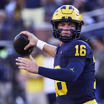 Aug 31, 2024; Ann Arbor, Michigan, USA;  Michigan Wolverines quarterback Davis Warren (16) warms up before the game against the Fresno State Bulldogs at Michigan Stadium. Mandatory Credit: Rick Osentoski-Imagn Images