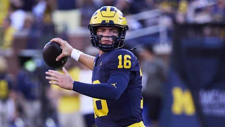 Aug 31, 2024; Ann Arbor, Michigan, USA;  Michigan Wolverines quarterback Davis Warren (16) warms up before the game against the Fresno State Bulldogs at Michigan Stadium. Mandatory Credit: Rick Osentoski-Imagn Images