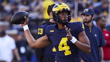 Aug 31, 2024; Ann Arbor, Michigan, USA;  Michigan Wolverines quarterback Jayden Denegal (4) warms up before the game against the Fresno State Bulldogs at Michigan Stadium. Mandatory Credit: Rick Osentoski-Imagn Images