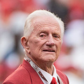 Arkansas Razorbacks former athletic director and coach Frank Broyles is honored with members of the 1964 national championship team before a game against the Alabama Crimson Tide at Donald W. Reynolds Razorback Stadium. Alabama defeated Arkansas 14-13.