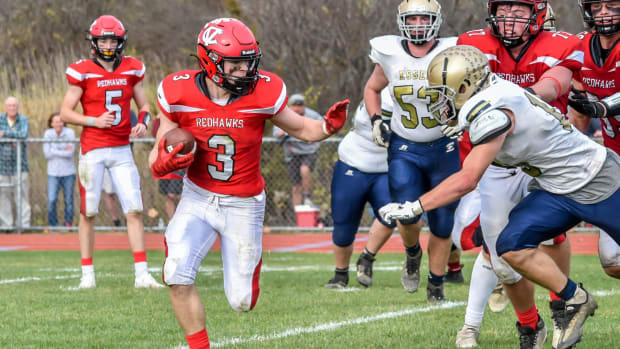 CVU's Jack Sumner turns the corner on Essex's Joshua Brown during the Redhawks' D1 football semifinal vs the Hornets