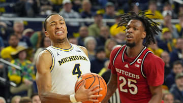 Michigan Wolverines guard Nimari Burnett (4) is fouled by Rutgers Scarlet Knights guard Jeremiah Williams (25) during the first half at Crisler Center in Ann Arbor on Thursday, Feb. 27, 2025.