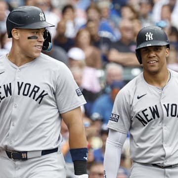 Sep 6, 2024; Chicago, Illinois, USA; New York Yankees outfielder Aaron Judge (99) and New York Yankees outfielder Juan Soto (22) celebrate after scoring agianst the Chicago Cubs during the third inning at Wrigley Field. Mandatory Credit: Kamil Krzaczynski-Imagn Images