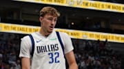 Oct 11, 2025; Dallas, Texas, USA; Dallas Mavericks forward Cooper Flagg (32) holds the basketball after a foul call in the second half of a game against the Charlotte Hornets at American Airlines Center. Mandatory Credit: Raymond Carlin III-Imagn Images