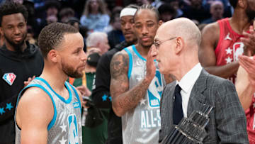 February 20, 2022; Cleveland, Ohio, USA; NBA commissioner Adam Silver (right) presents Team LeBron guard Stephen Curry of the Golden State Warriors (30) with the The Kobe Bryant Trophy for being the most valuable player after the 2022 NBA All-Star Game at Rocket Mortgage FieldHouse. Mandatory Credit: Kyle Terada-Imagn Images