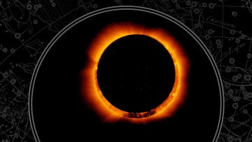 An annular solar eclipse appears like a ring of fire in the night sky.