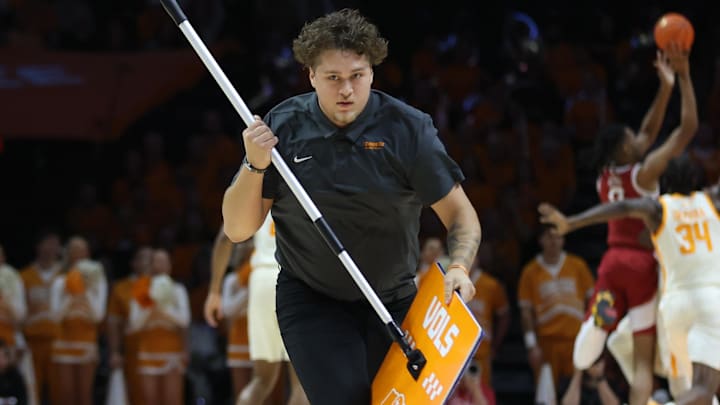 Emblematic of Tennessee wiping the floor with the Razorbacks is this member of the Vols' cleanup crew dashing off the court with live action happening in the background. Arkansas led 12-8 but was outscored 28-8 and never again trailed by less than double digits. Emblematic of Tennessee wiping the floor with the Razorbacks is this member of the Vols' cleanup crew dashing off the court with live action happening in the background. Arkansas led 12-8 but was outscored 28-8 and never again trailed by less than double digits.