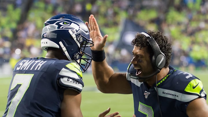 Seattle Seahawks quarterback Russell Wilson celebrates with Geno Smith after a touchdown