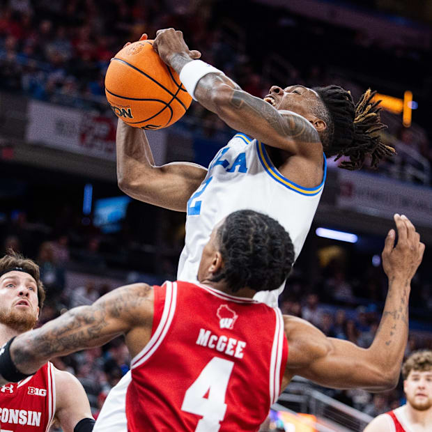 UCLA Bruins guard Dylan Andrews (2) shoots the ball while Wisconsin Badgers guard Kamari McGee (4) defends.