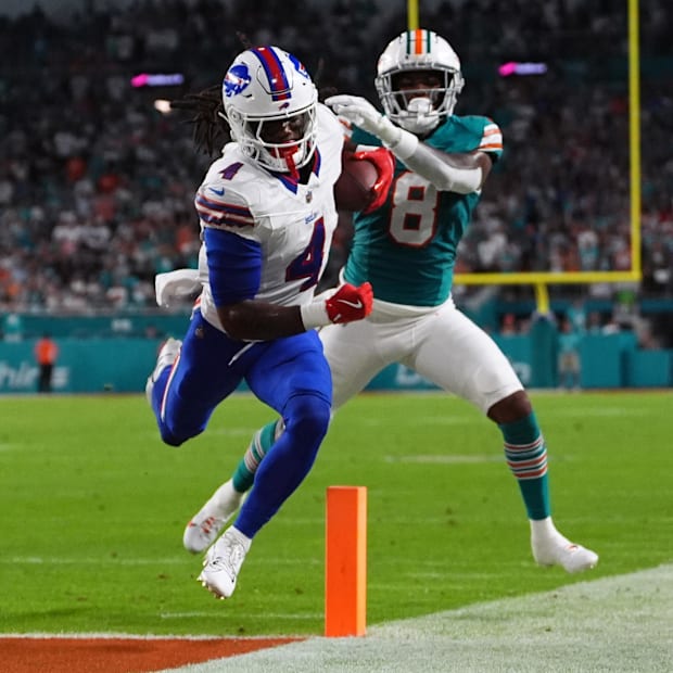 James Cook runs by Jevon Holland