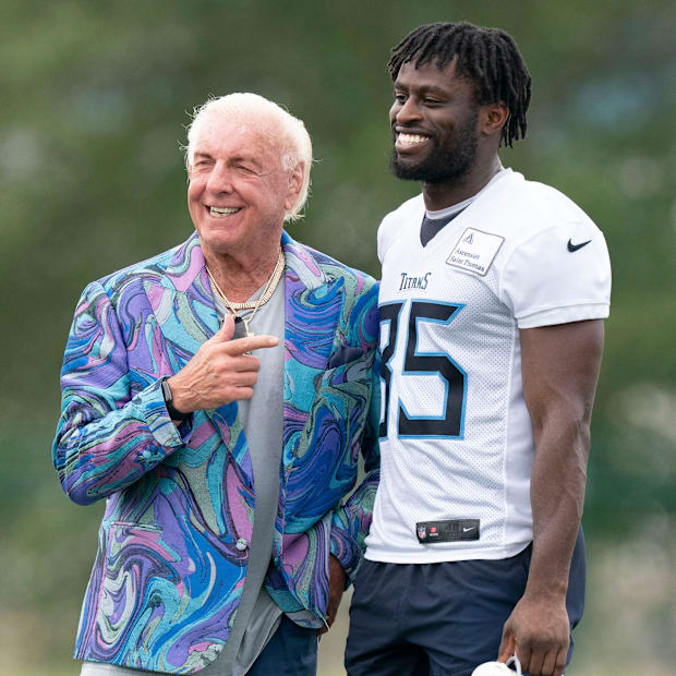 Professional wrestler Ric Flair poses for a picture with Tennessee Titans tight end Chig Okonkwo (85) after a training camp p