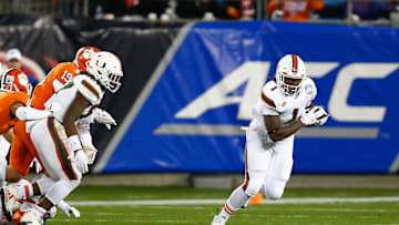 Dec 2, 2017; Charlotte, NC, USA; Miami Hurricanes running back Mark Walton (1) picks up a fumble on the kickoff in the third quarter against the Clemson Tigers in the ACC championship game at Bank of America Stadium. Mandatory Credit: Jeremy Brevard-Imagn Images