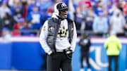 Nov 23, 2024; Kansas City, Missouri, USA;  Colorado head coach Deion Sanders paces the field during the 2nd quarter between the Kansas Jayhawks and the Colorado Buffaloes at GEHA Field at Arrowhead Stadium. Mandatory Credit: Nick Tre. Smith-Imagn Images