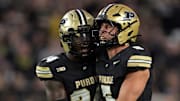 Purdue Boilermakers defensive back An'Darius Coffey (24) celebrates a sack with linebacker Charles Correa (5) 