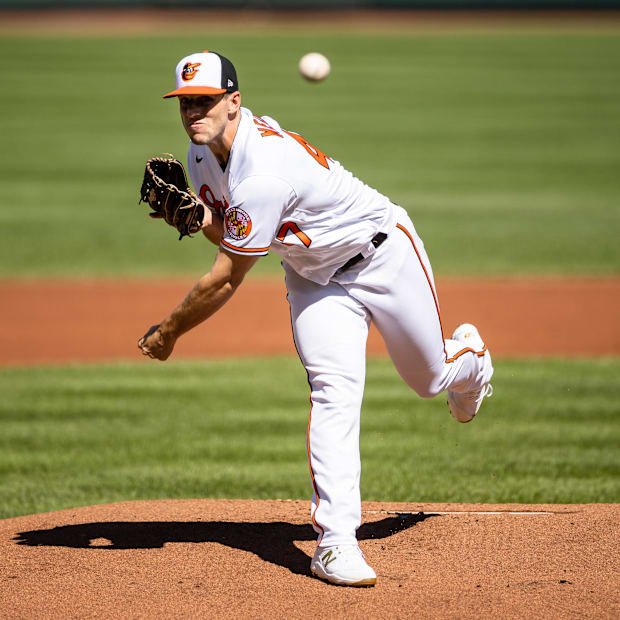 John Means (47) throws a pitch 
