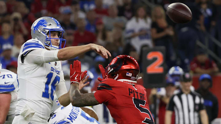 The Lions overcame five interceptions by Jared Goff to beat the Texans and remain the top seed in the NFC.