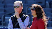 Oct 1, 2025; Bronx, New York, USA; Boston Red Sox owner John Henry (left) stands on the field with his wife Linda Pizzuti Henry during batting practice before game two of the Wildcard round of the 2025 MLB playoffs against the New York Yankees at Yankee Stadium. Mandatory Credit: Brad Penner-Imagn Images