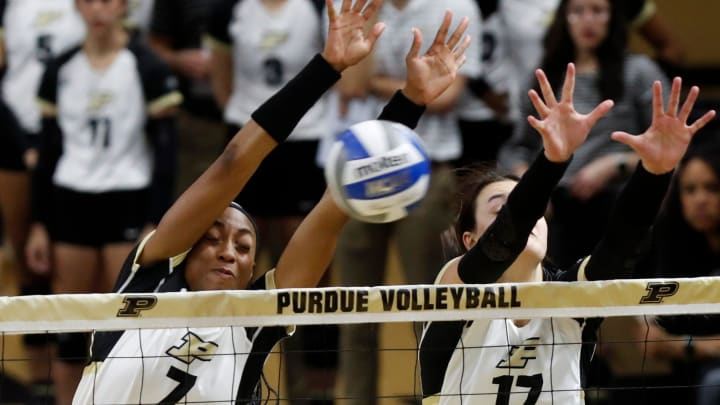 Purdue Boilermakers Raven Colvin (7) and Purdue Boilermakers Eva Hudson (17) defend a spike 