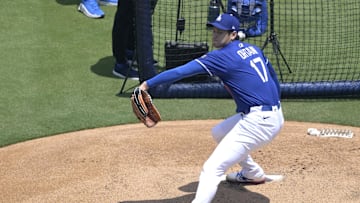 May 31, 2025; Los Angeles, California, USA;  Los Angeles Dodgers pitching coach Mark Prior (99) and interpreter Will Ireton watch as Shohei Ohtani (17) throws live batting practice prior to the game against the New York Yankees at Dodger Stadium. Mandatory Credit: Jayne Kamin-Oncea-Imagn Images