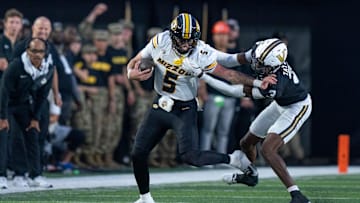 Missouri's quarterback Matt Zollers (5) is brought down by Vanderbilt's cornerback Kolbey Taylor (3) during their game at FirstBank Stadium in Nashville, Tenn., Saturday, Oct. 25, 2025.