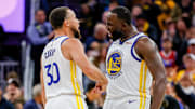 Oct 23, 2025; San Francisco, California, USA; Golden State Warriors guard Stephen Curry (30) and Golden State Warriors forward Draymond Green (23) celebrate during overtime against the Denver Nuggets at Chase Center. Mandatory Credit: Bob Kupbens-Imagn Images