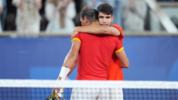 Jul 27, 2024; Paris, France; Rafael Nadal (ESP) and Carlos Alcaraz (ESP) celebrate defeating Maximo Gonzalez (ARG) and Andres Molteni (ARG) in a men's tennis doubles match during the Paris 2024 Olympic Summer Games at Stade Roland Garros. Mandatory Credit: Amber Searls-USA TODAY Sports