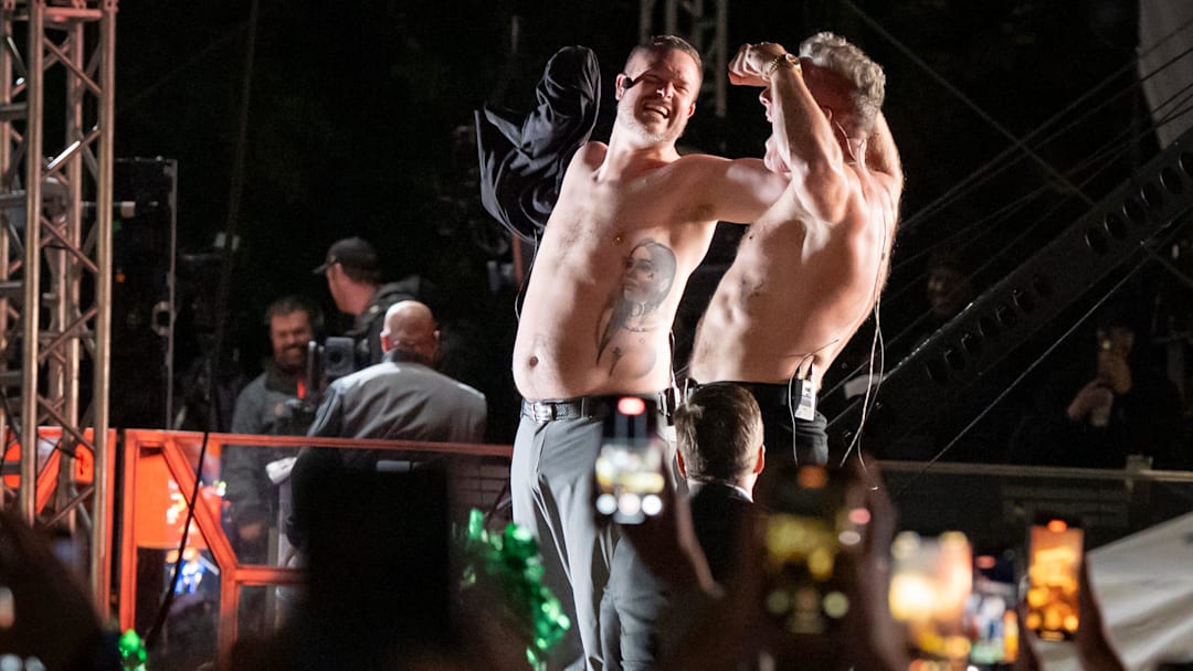 Oregon head coach Dan Lanning, left, and host Pat McAfee strip off their shirts to rally the crowd during ESPN’s “College GameDay” on the campus of the University of Oregon on Oct. 11, 2025, in Eugene, Oregon.