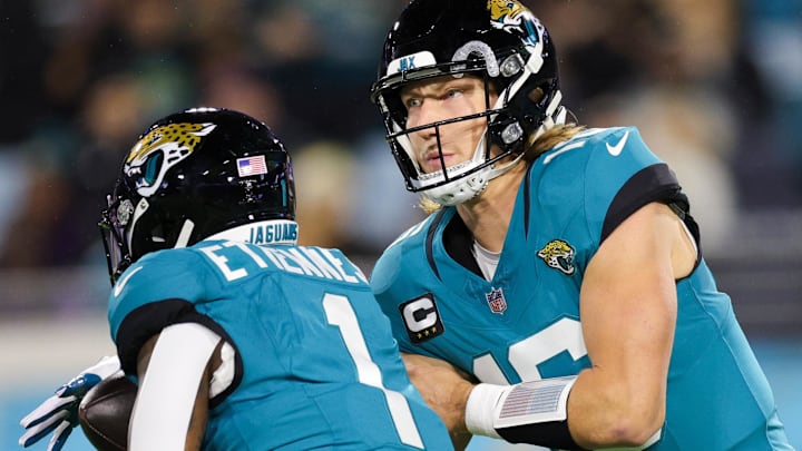 Dec 17, 2023; Jacksonville, Florida, USA;  Jacksonville Jaguars quarterback Trevor Lawrence (16) hands off to running back Travis Etienne Jr. (1) against the Baltimore Ravens in the first quarter at EverBank Stadium. Mandatory Credit: Nathan Ray Seebeck-Imagn Images