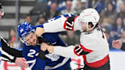 Mar 15, 2025; Toronto, Ontario, CAN;  Ottawa Senators forward Ridly Greig (71) lands a punch on Toronto Maple Leafs forward Scott Laughton (24) as they fight in the second period at Scotiabank Arena. Mandatory Credit: Dan Hamilton-Imagn Images
