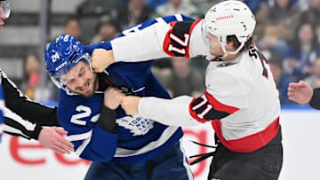 Mar 15, 2025; Toronto, Ontario, CAN;  Ottawa Senators forward Ridly Greig (71) lands a punch on Toronto Maple Leafs forward Scott Laughton (24) as they fight in the second period at Scotiabank Arena. Mandatory Credit: Dan Hamilton-Imagn Images