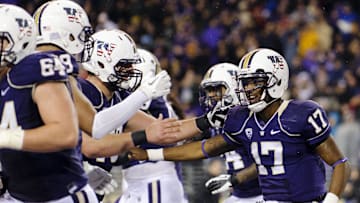 Nov 9, 2013; Seattle, WA, USA; Washington Huskies quarterback Keith Price (17) celebrate with teammates after Price ran the ball in for a touchdown against the Colorado Buffaloes during the 1st half at Husky Stadium. Mandatory Credit: Steven Bisig-Imagn Images